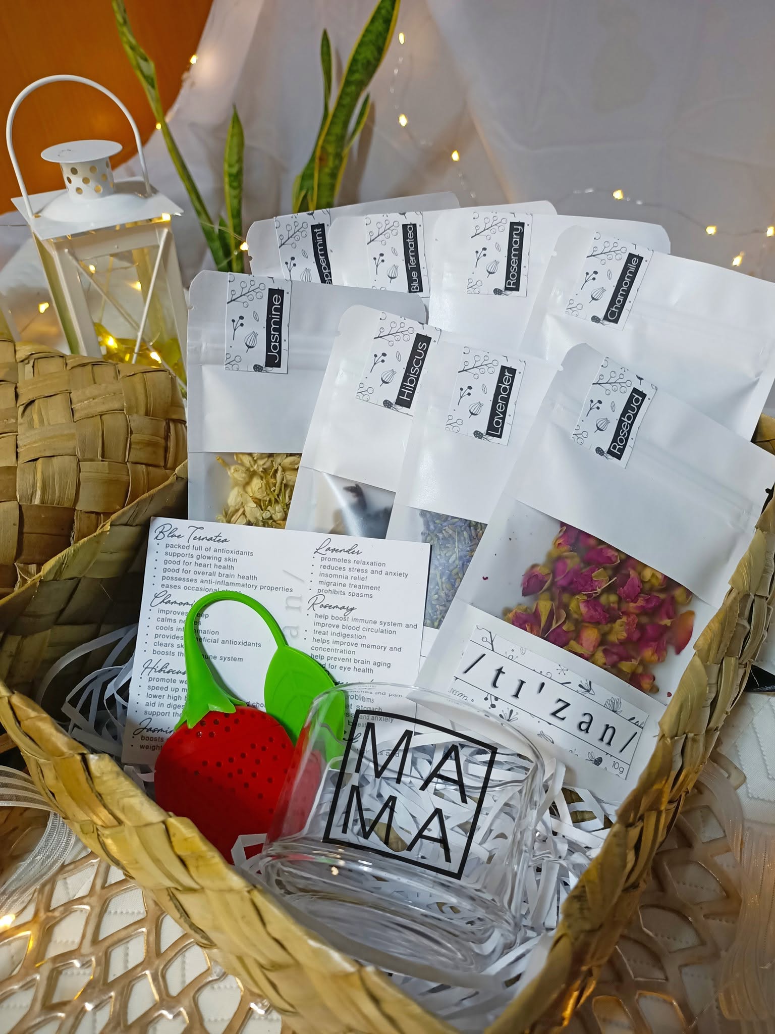 A basket filled with Tizan herbal tea pouches and accessories