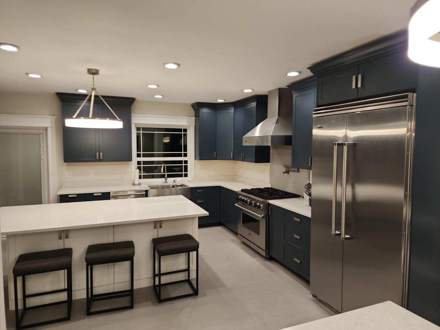 Custom navy kitchen remodel with commercial range