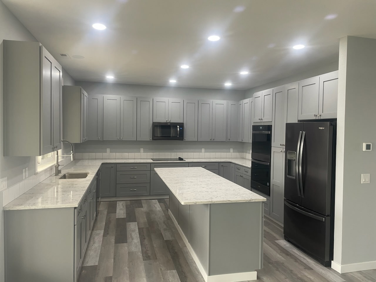 Modern gray kitchen remodel with marble island