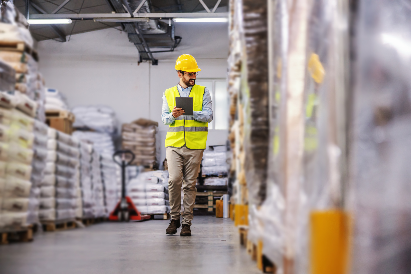 Warehouse worker reviewing information on a tablet.
