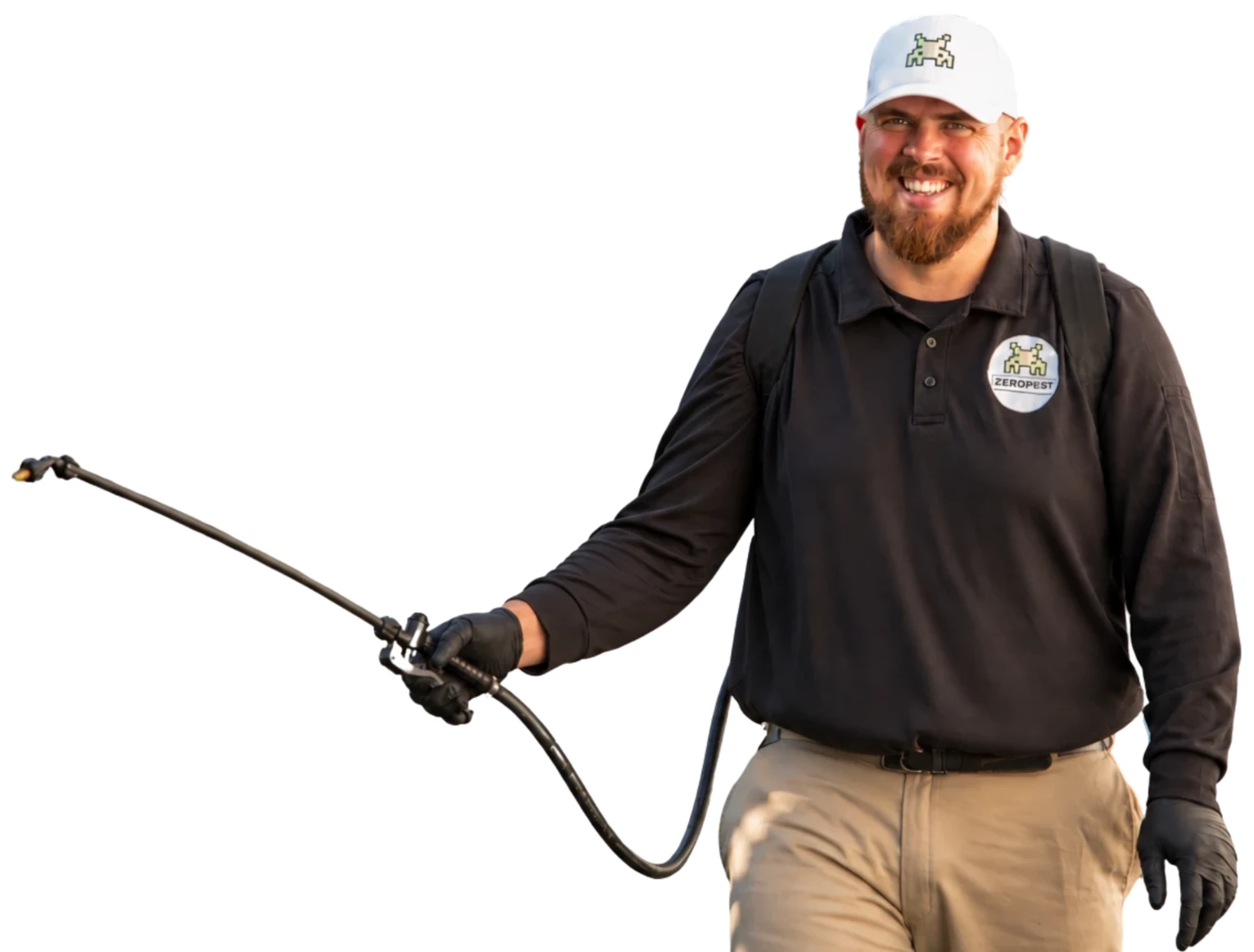 Alex, co-owner of Zero Pest, smiling in a backyard with his sprayer