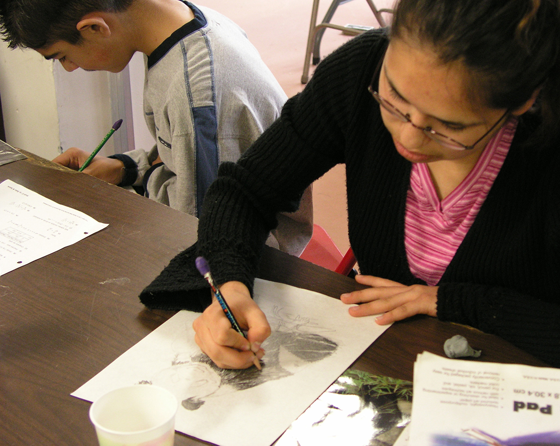 Homeschool students gathered around an art demonstration