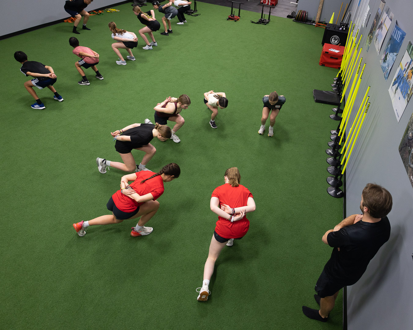 Group slideboard training at Jungle Athletics Calgary SAP — skating position under load