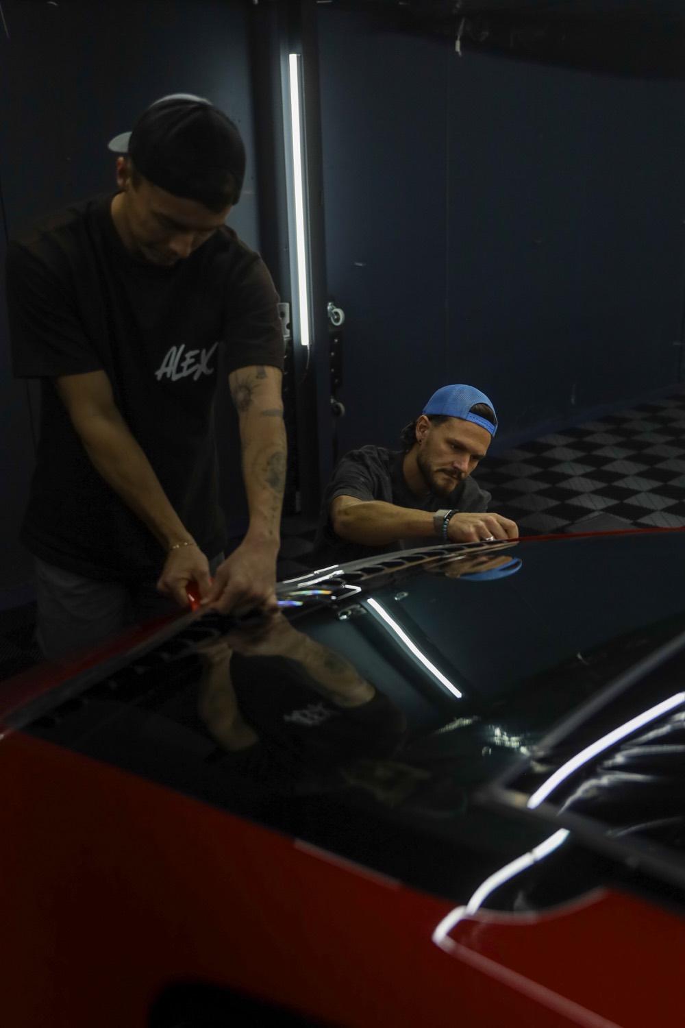 Installer working film along a panel edge
