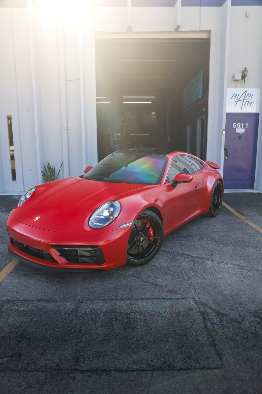 Red Porsche 911 outside the shop