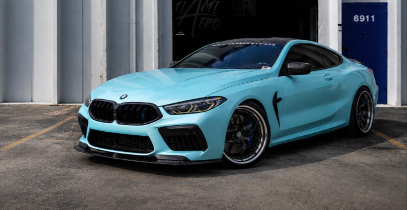 Light blue BMW M8 outside the shop