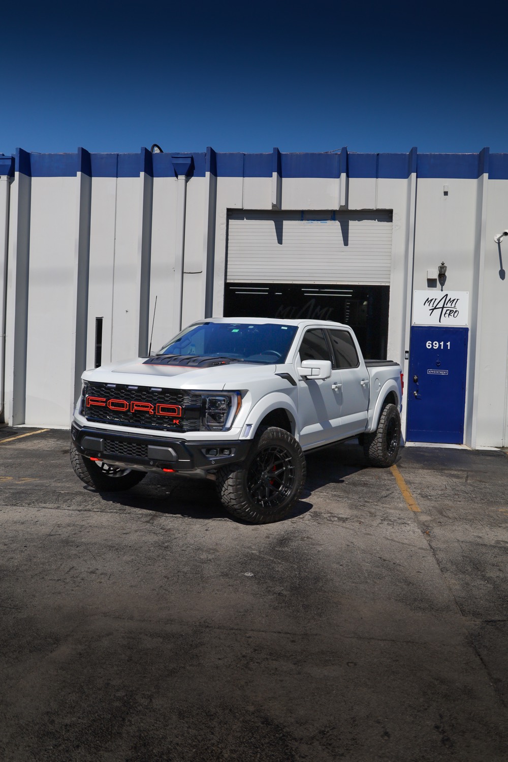 White Ford Raptor outside the shop