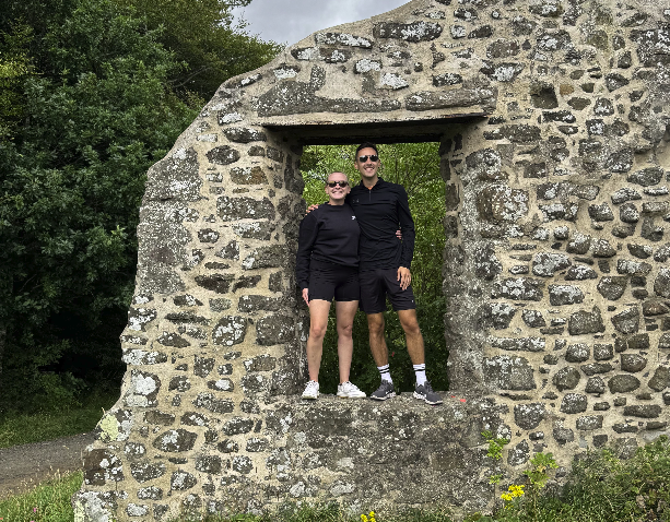 Georgia and KJ standing in a stone ruin window