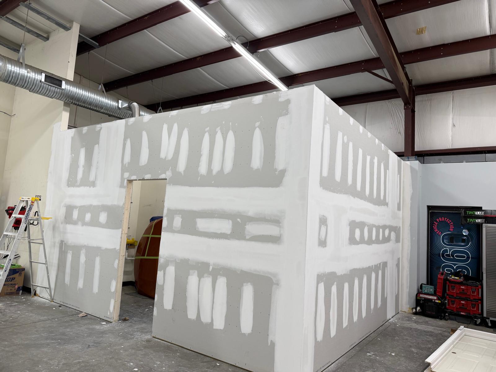 A professional remodeler carefully installing new kitchen cabinets in a modern home