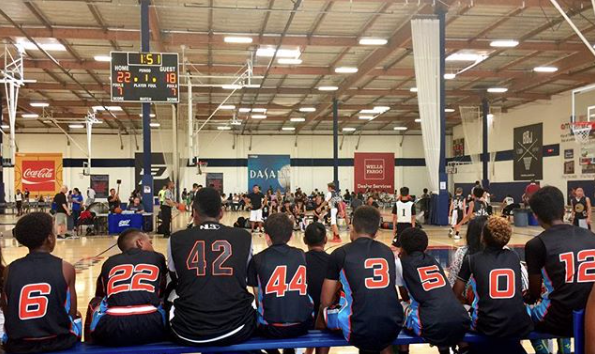Coach B. Law standing with a group of young basketball players after training session