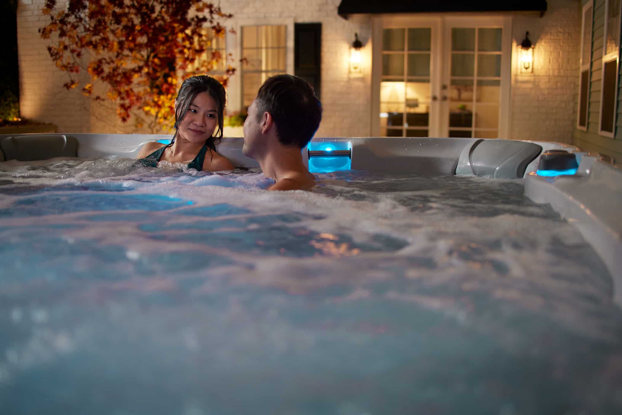 couple relax in sundance hot tub