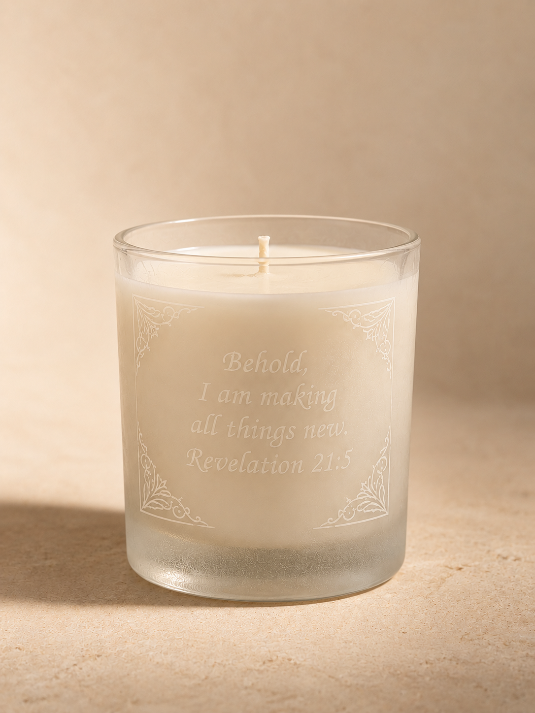 The 10 oz Casa Selah Prayer Candle: cream wax in a frosted glass vessel etched with the face of Christ crowned in thorns.