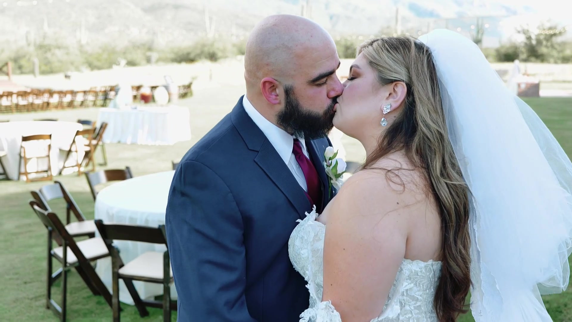 Bride and groom framed by desert mountains
