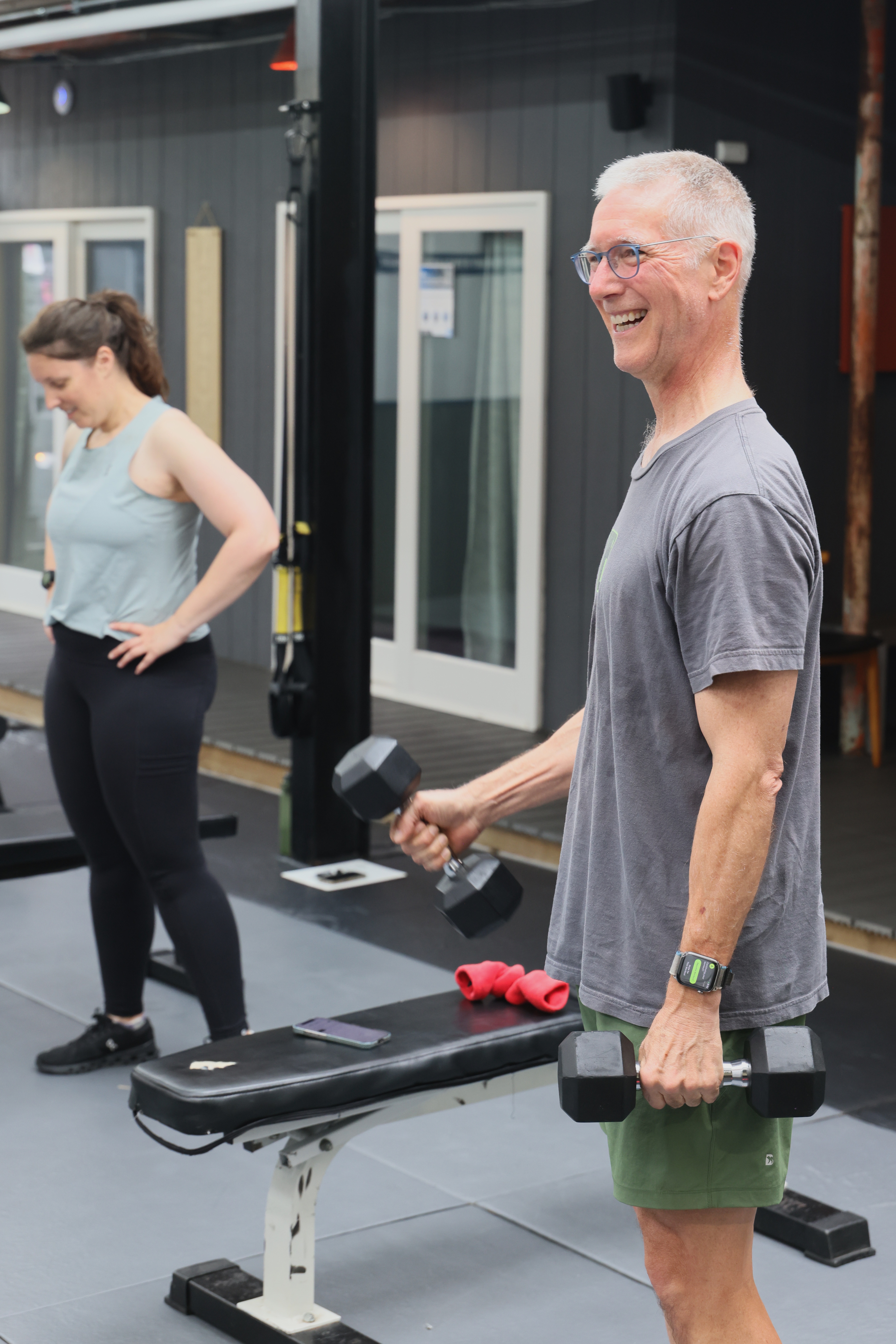 A Revolutionary Fitness member training with dumbbells
