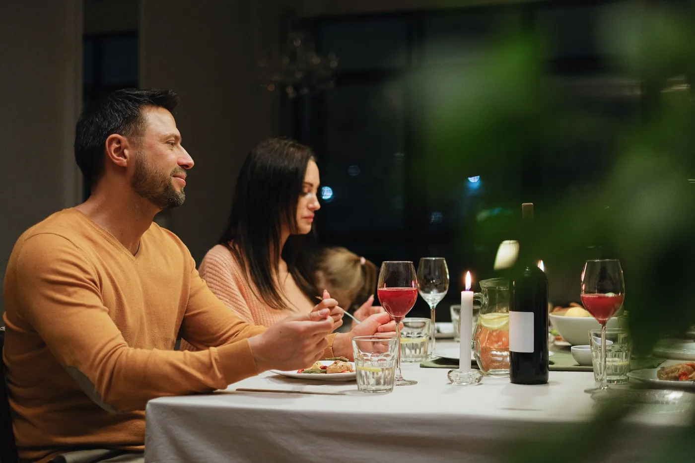 A family enjoying dinner together in the evening
