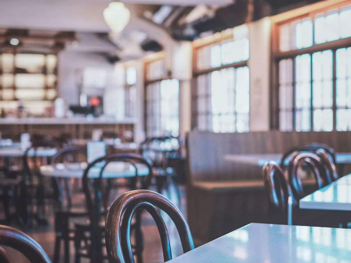 Warm and inviting restaurant interior with classic wooden chairs and tables. Perfect setting for dining.