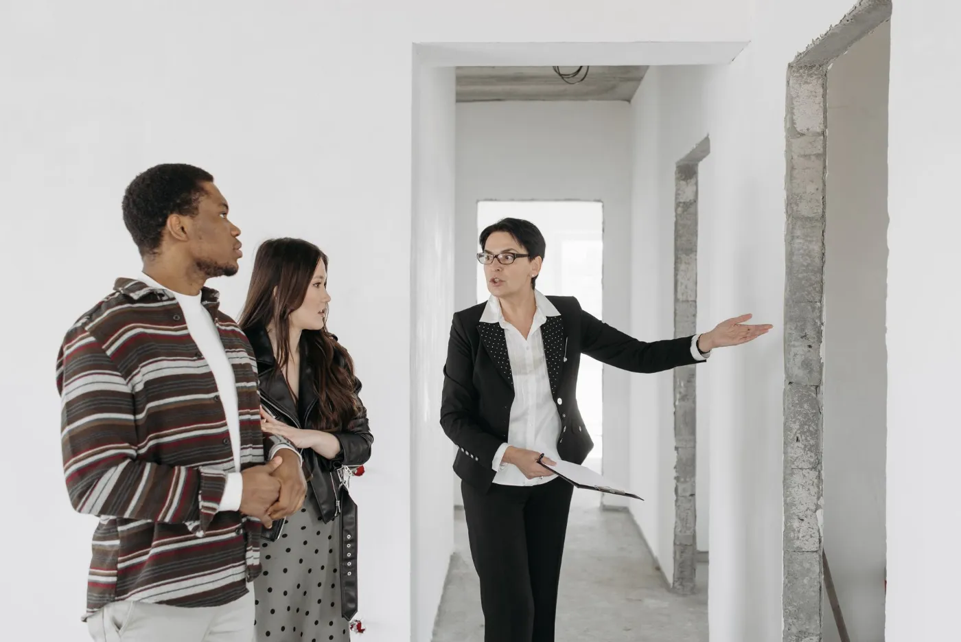 A real estate agent showing a home to a couple