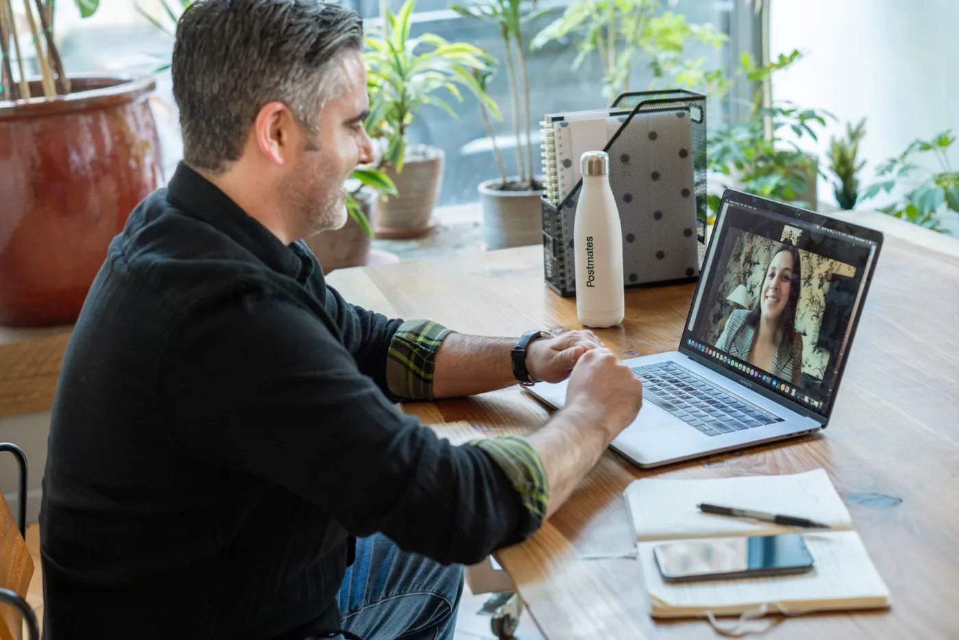 A coach smiling on a video call with a client