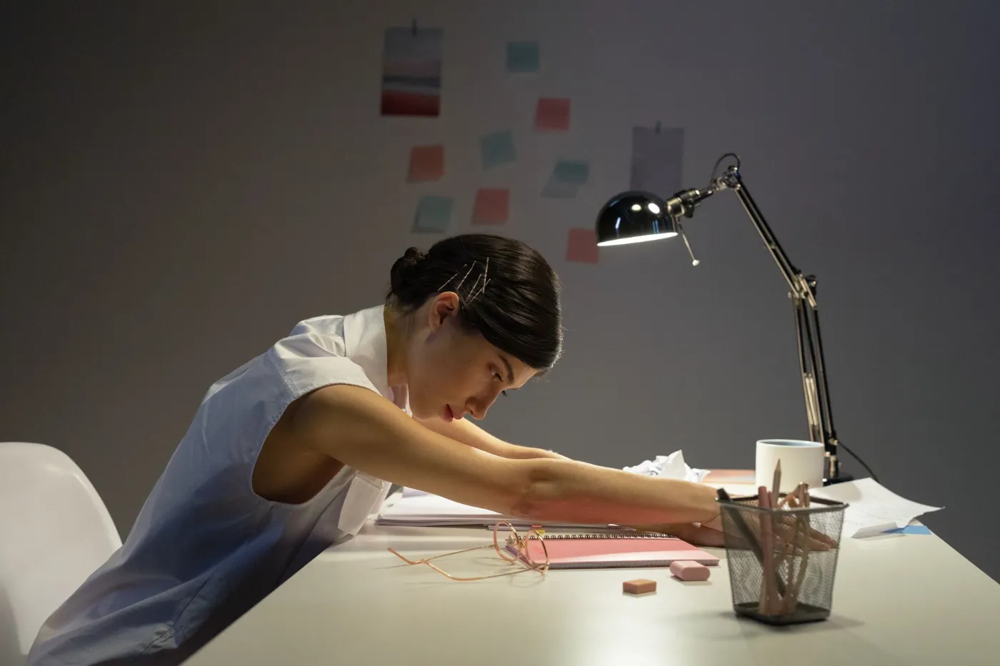 An owner slumped over her desk late at night, still working