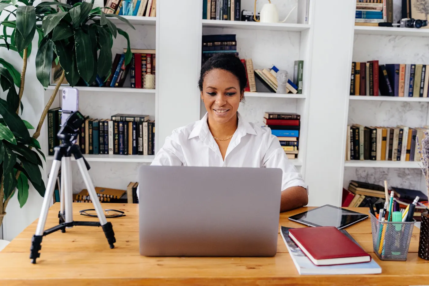 A woman working at her laptop at a bright desk