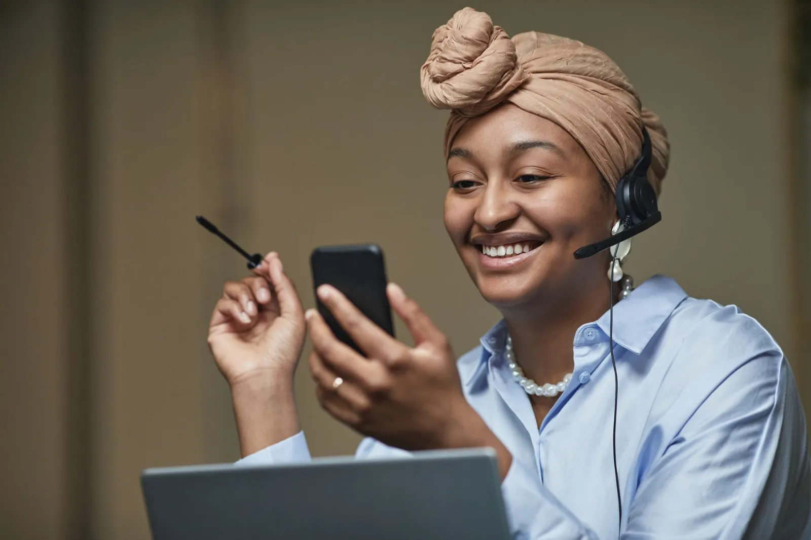 A smiling woman reading something good on her phone