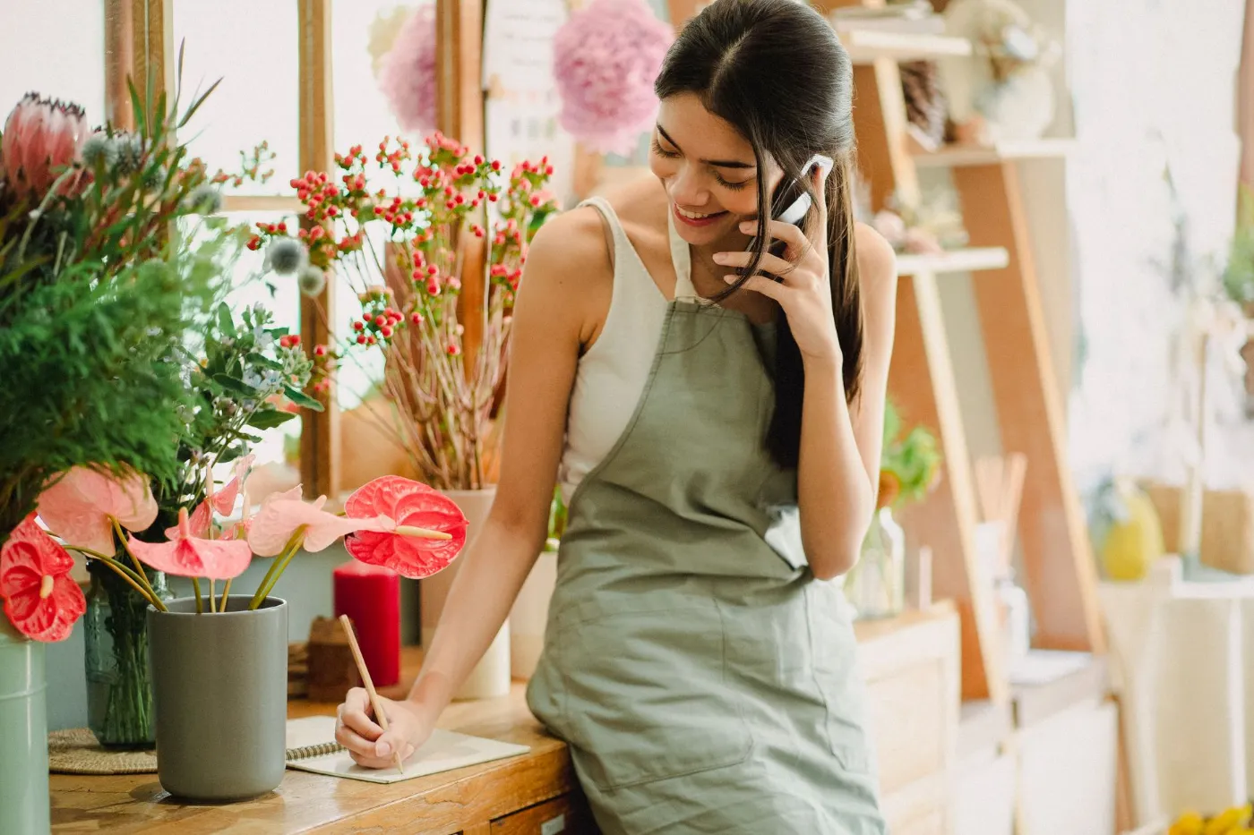 A florist checking her phone in her shop