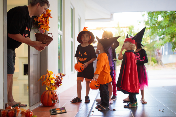 Neighbor handing candies Neighbor handing candies