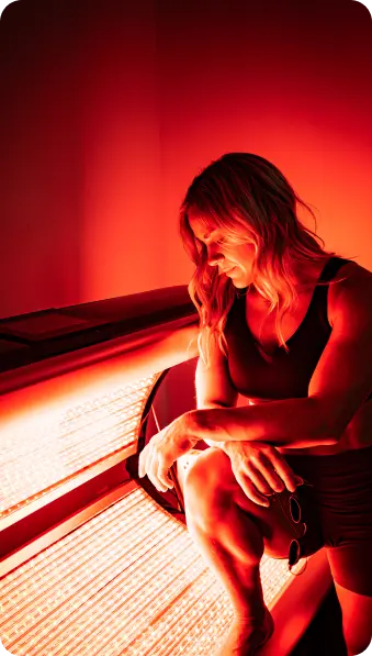 Client sitting by red light device