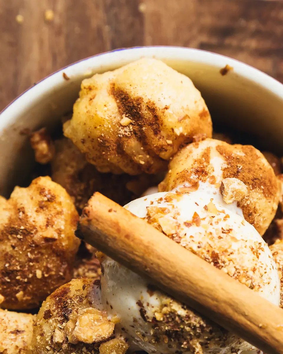 Loukoumades drizzled with honey, cinnamon and walnuts with vanilla ice cream