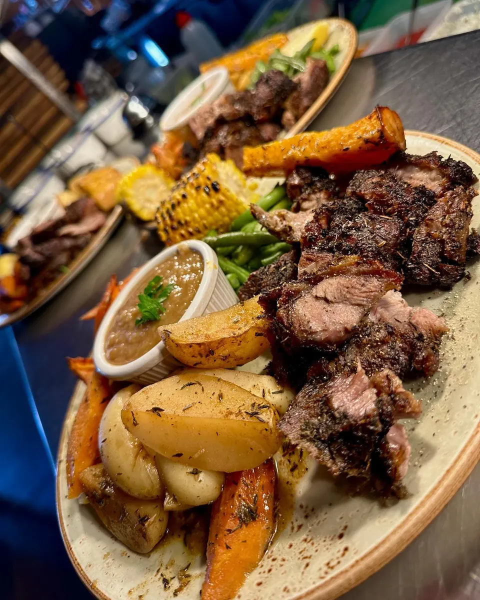 Sunday Greek-style lamb roast with potatoes, pumpkin, corn and gravy