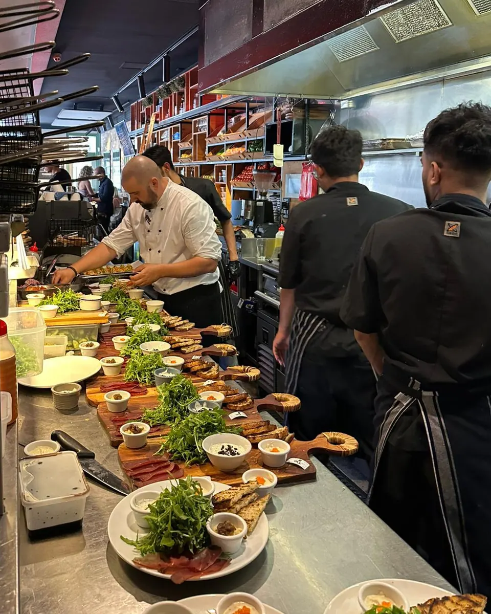 A row of share boards lined up at the kitchen pass