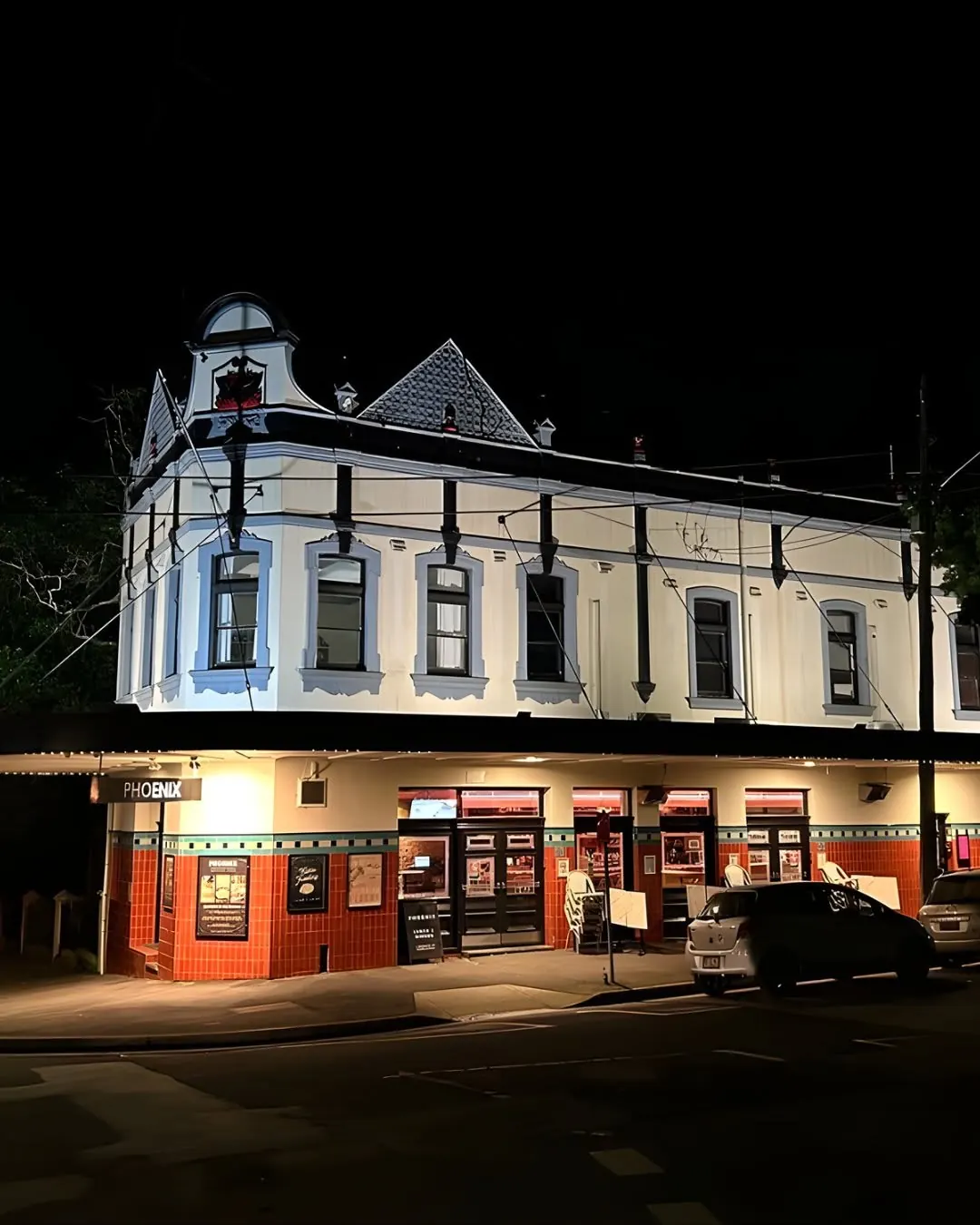 The Phoenix Hotel lit up at night on the corner of Moncur and Wallis Streets, Woollahra