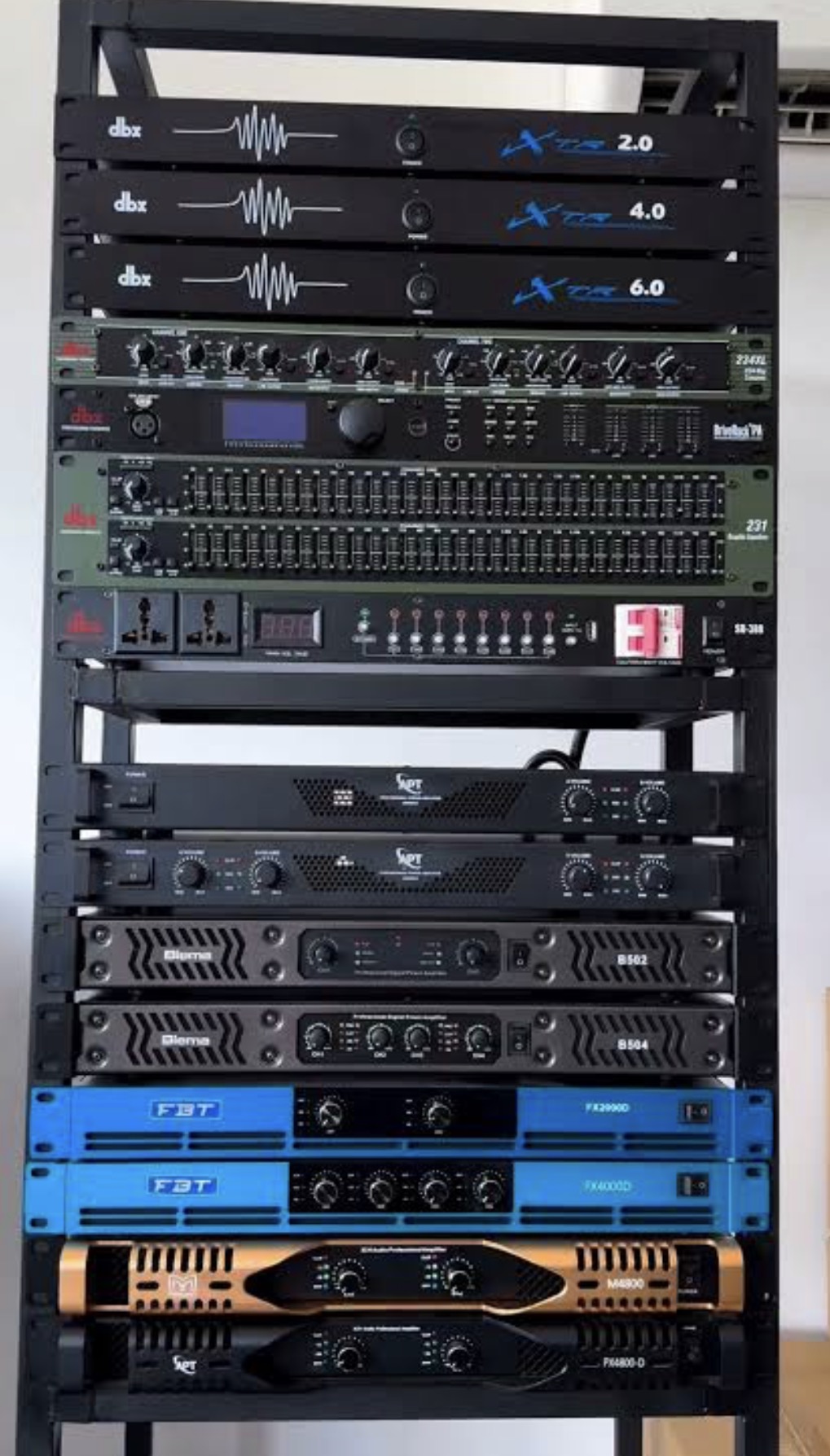Equipment rack with dbx processors and equalizers and several power amplifiers
