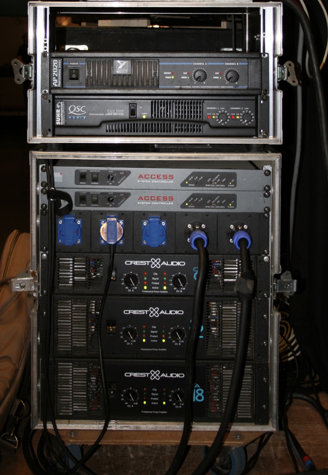 Rack of Crest Audio power amplifiers and system controllers wired for a live sound system