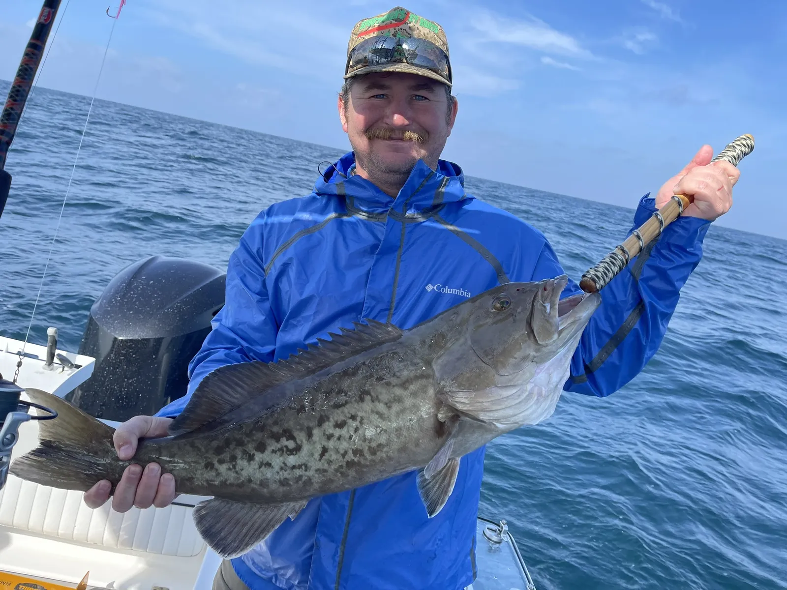 Group of friends showing off amberjack caught on a Destin deep-sea charter