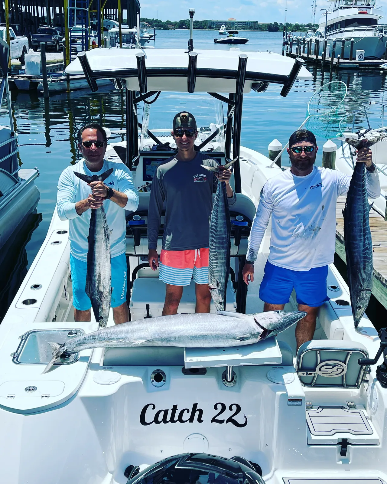Captain and mate netting a mahi mahi at the boat side in the Gulf of Mexico
