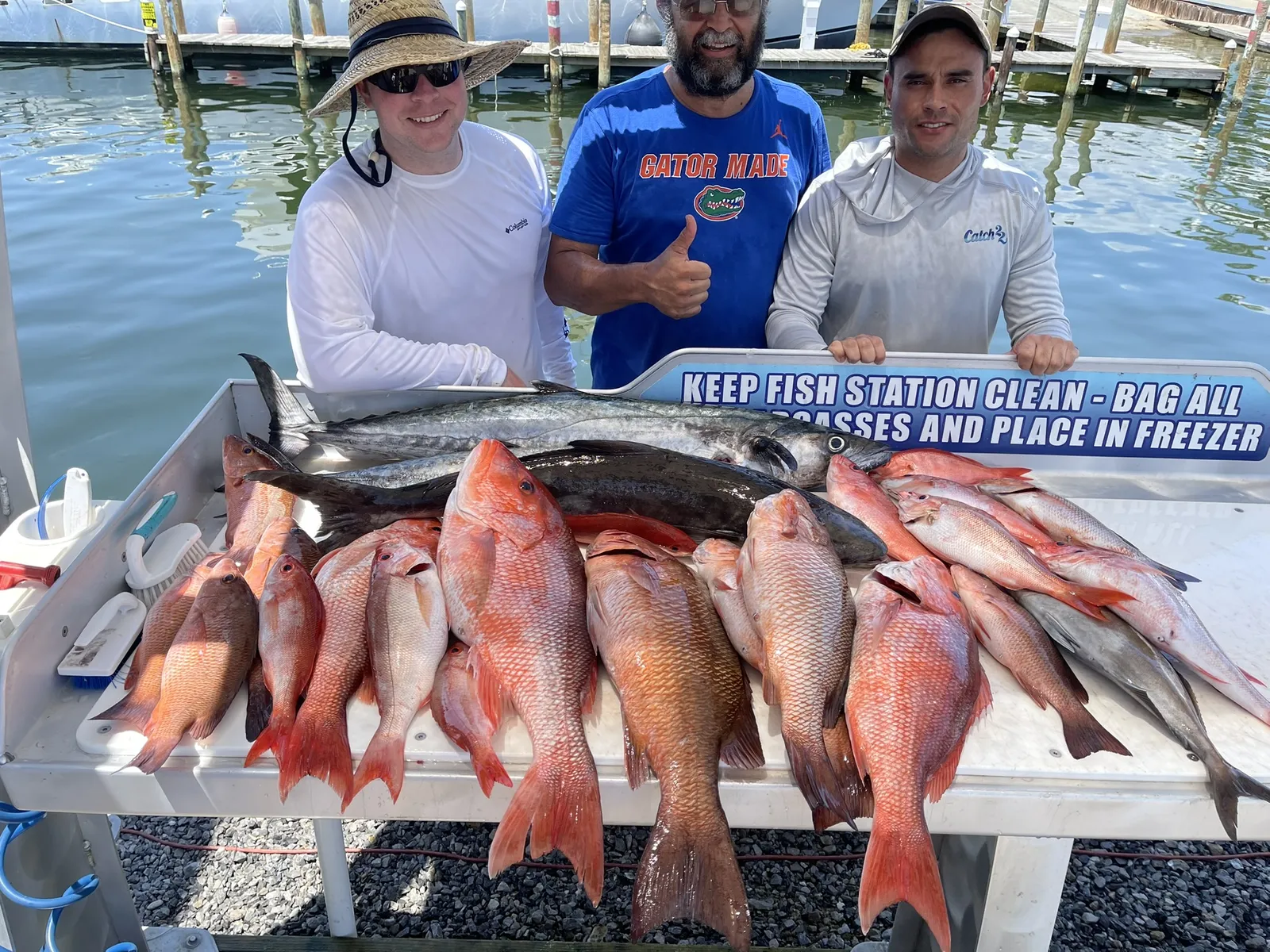 Couple posing with a red grouper caught offshore Destin, Florida