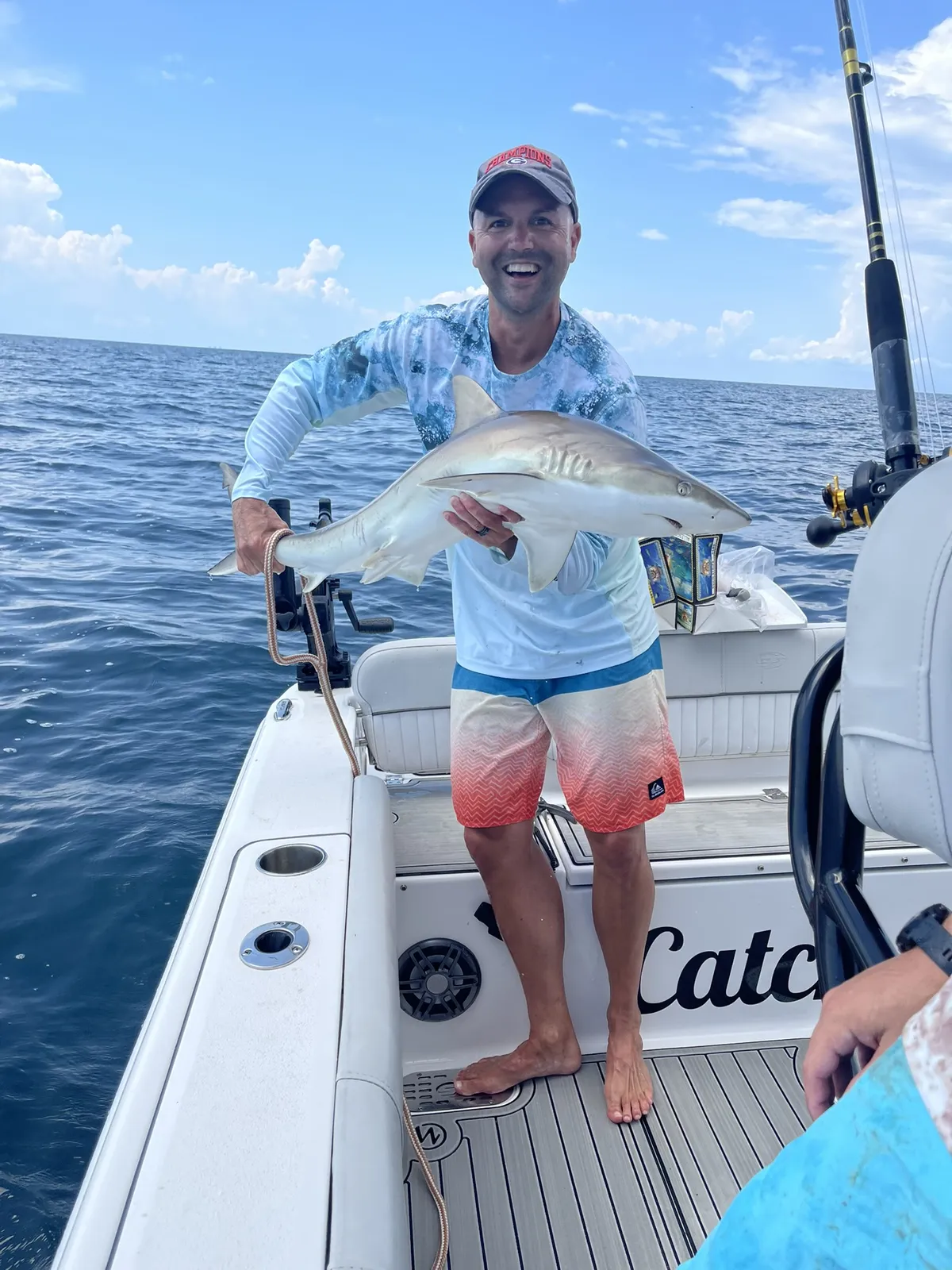 Group celebrating a successful offshore fishing trip on Catch 22