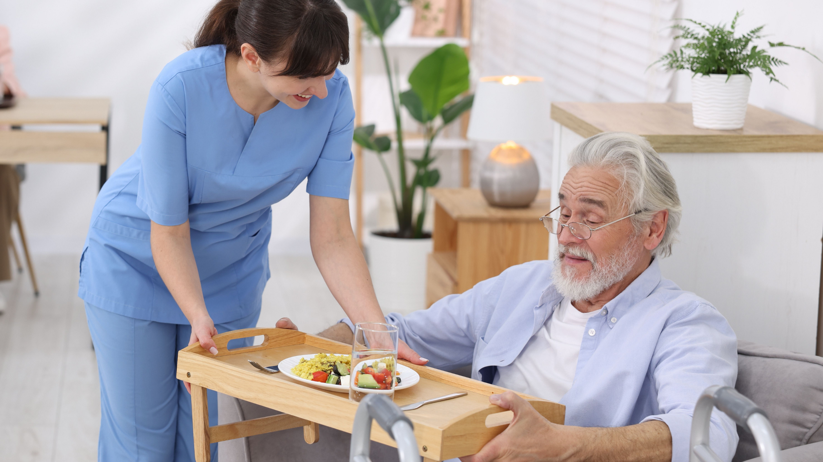 Home care services caregiver assisting senior with dementia during mealtime in Lakewood CA