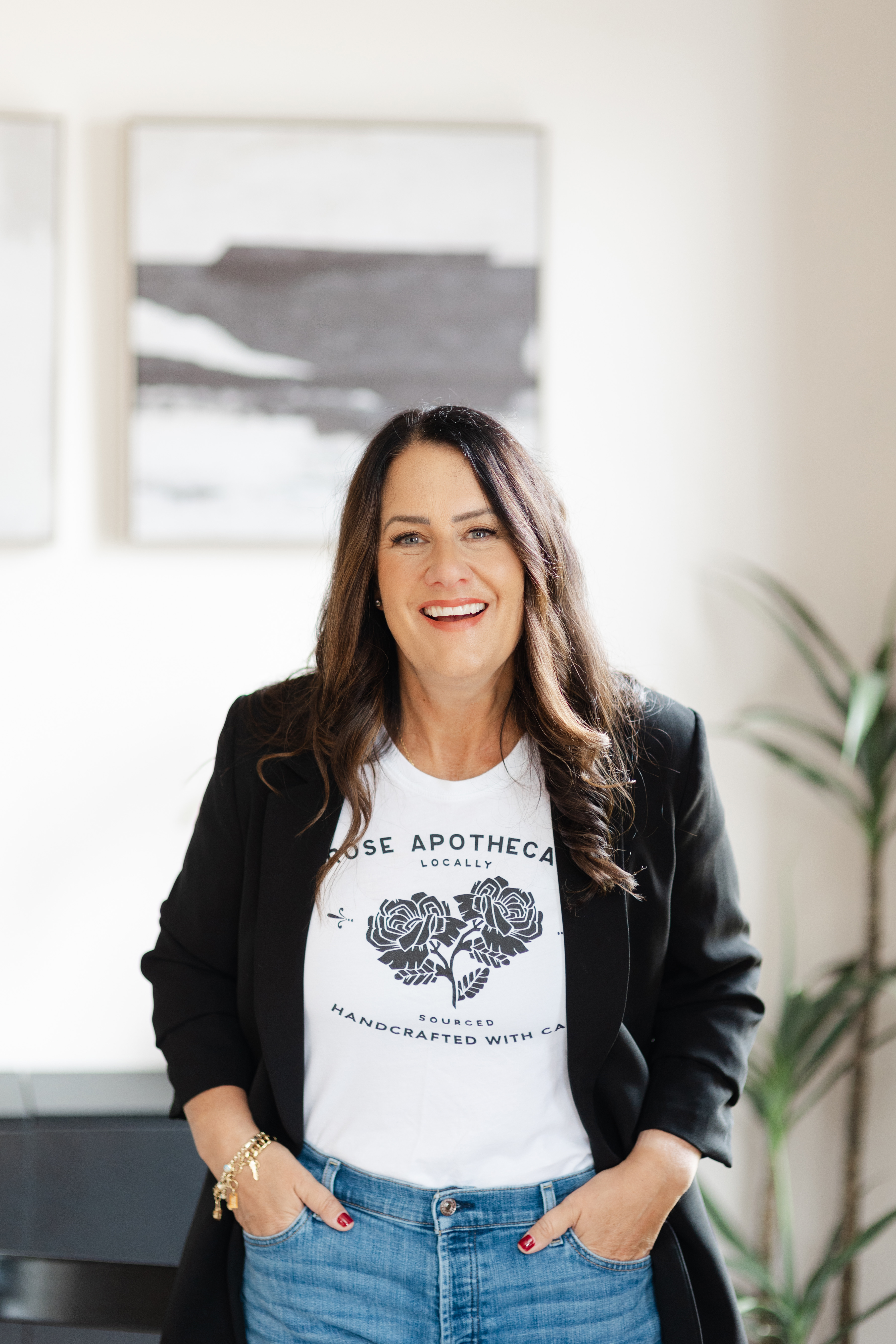 Sarah Price smiling in a black blazer and jeans