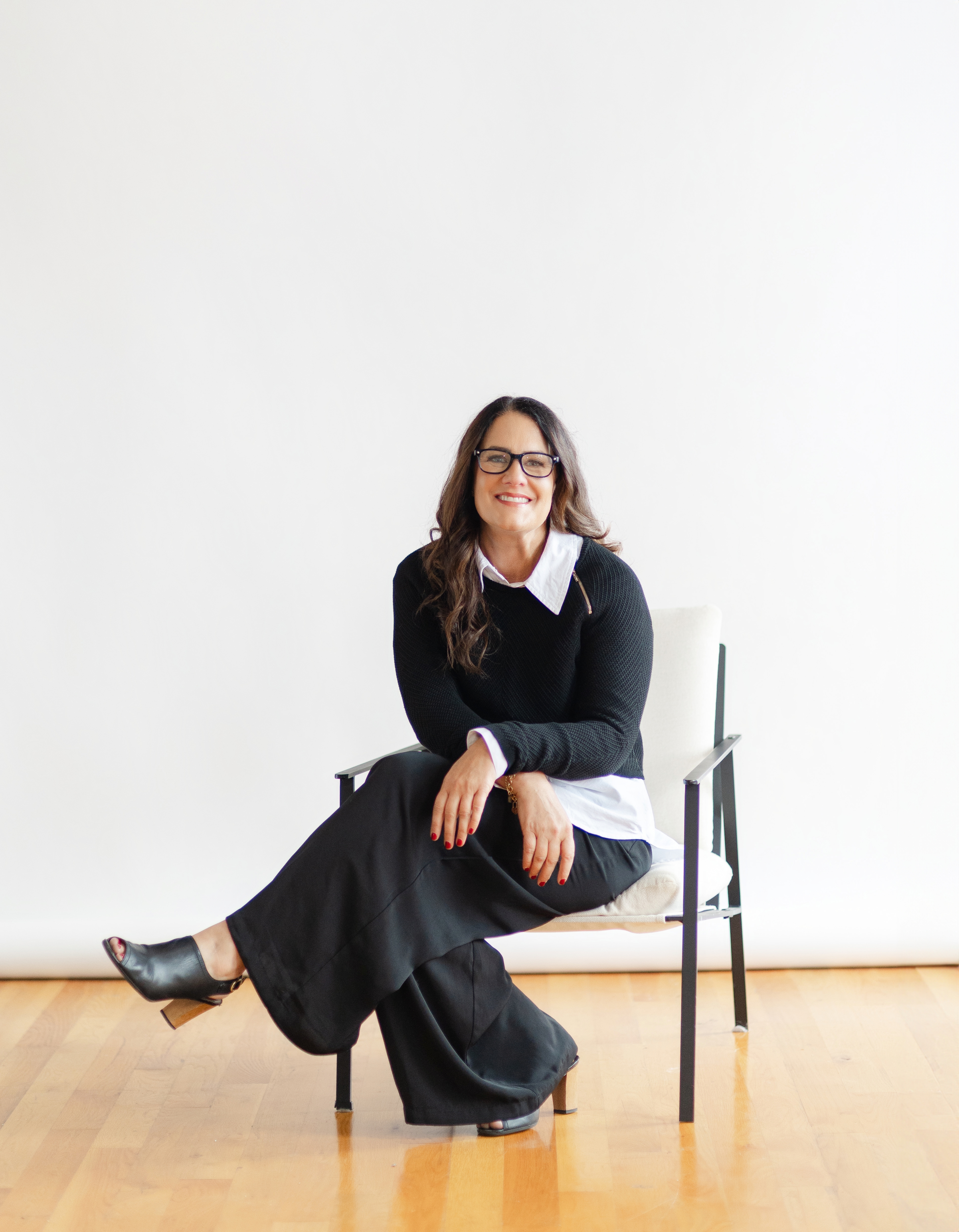 Sarah Price, Gallup-Certified Strengths Coach, seated in a chair