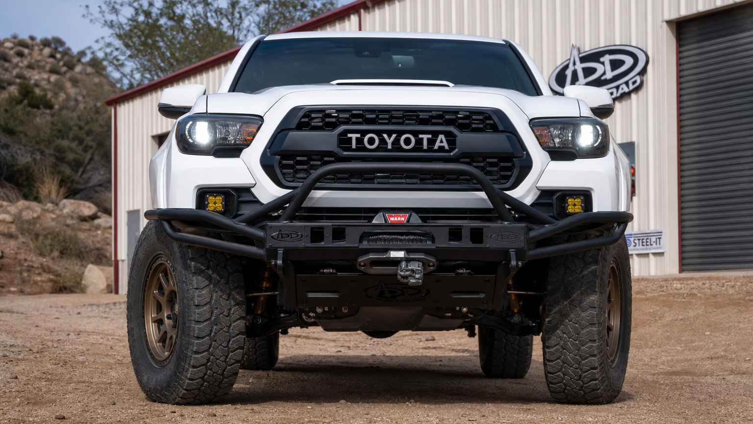 Project Redrock Toyota Tacoma front build shot showing ADD bumper and Warn winch