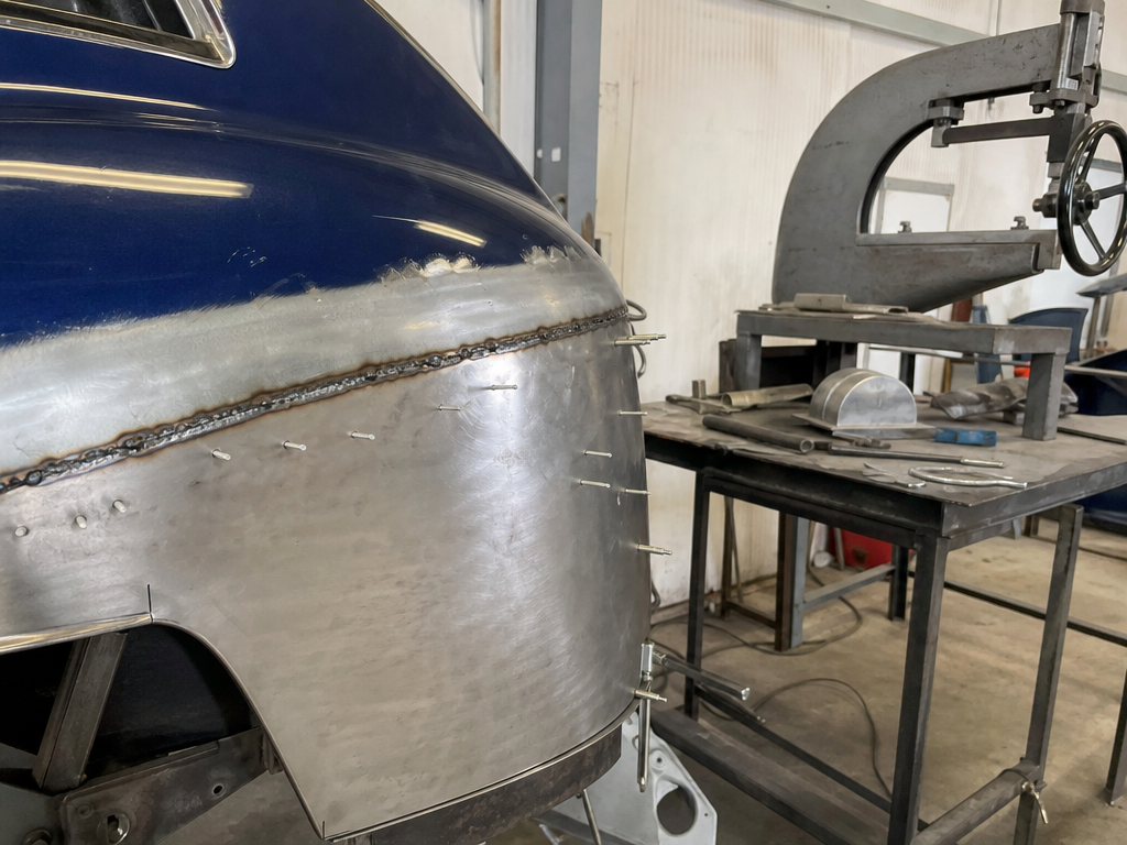 Hand-formed patch panel fitted to a classic car quarter panel