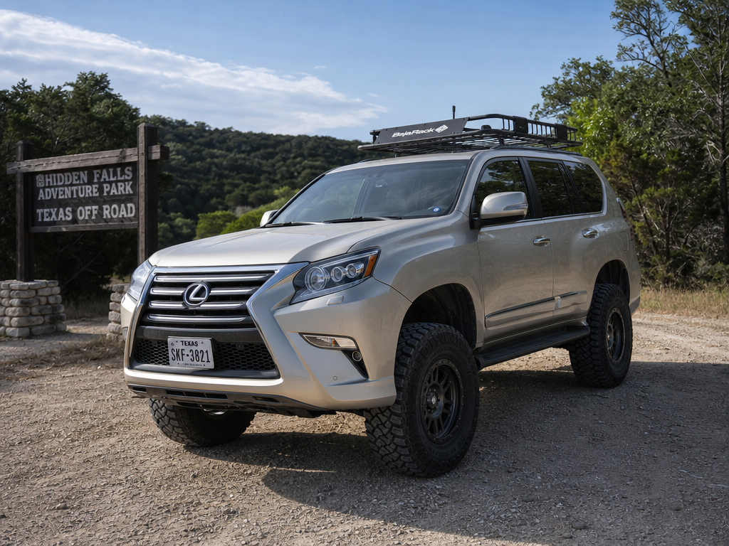 Lifted Lexus GX460 with all-terrain tires and roof rack on a Texas off-road trail