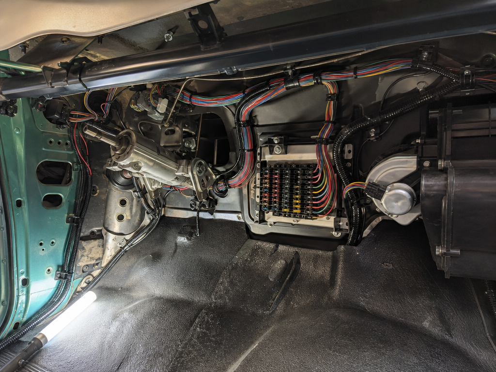 New wiring harness routed under the dash of a classic car
