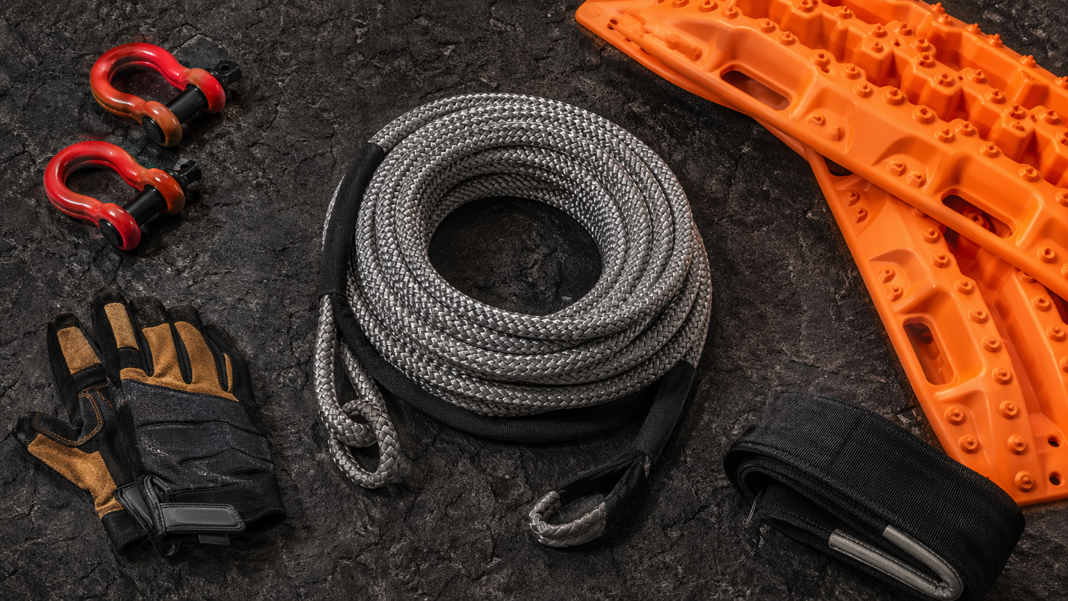 Recovery gear flat lay including kinetic rope shackles and traction boards