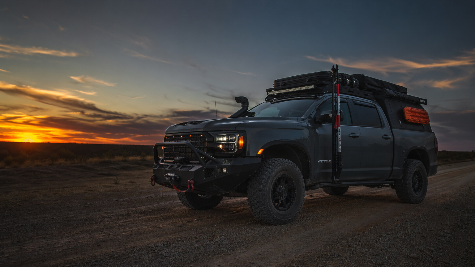 Completed full accessories build truck at dusk on Texas dirt road