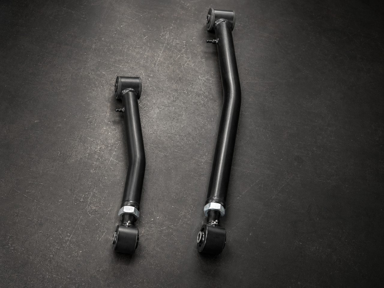 Short arm versus long arm control arm side by side showing dramatic length difference