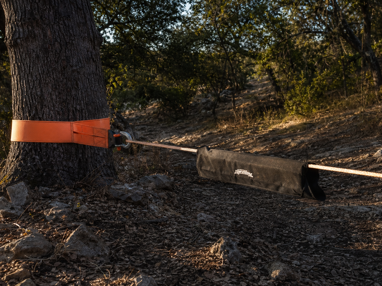 Correct winch rigging with tree saver strap bow shackle and dampener blanket