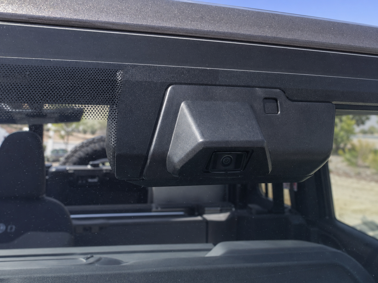 Jeep Wrangler JL forward facing camera sensor housing close-up showing ADAS technology